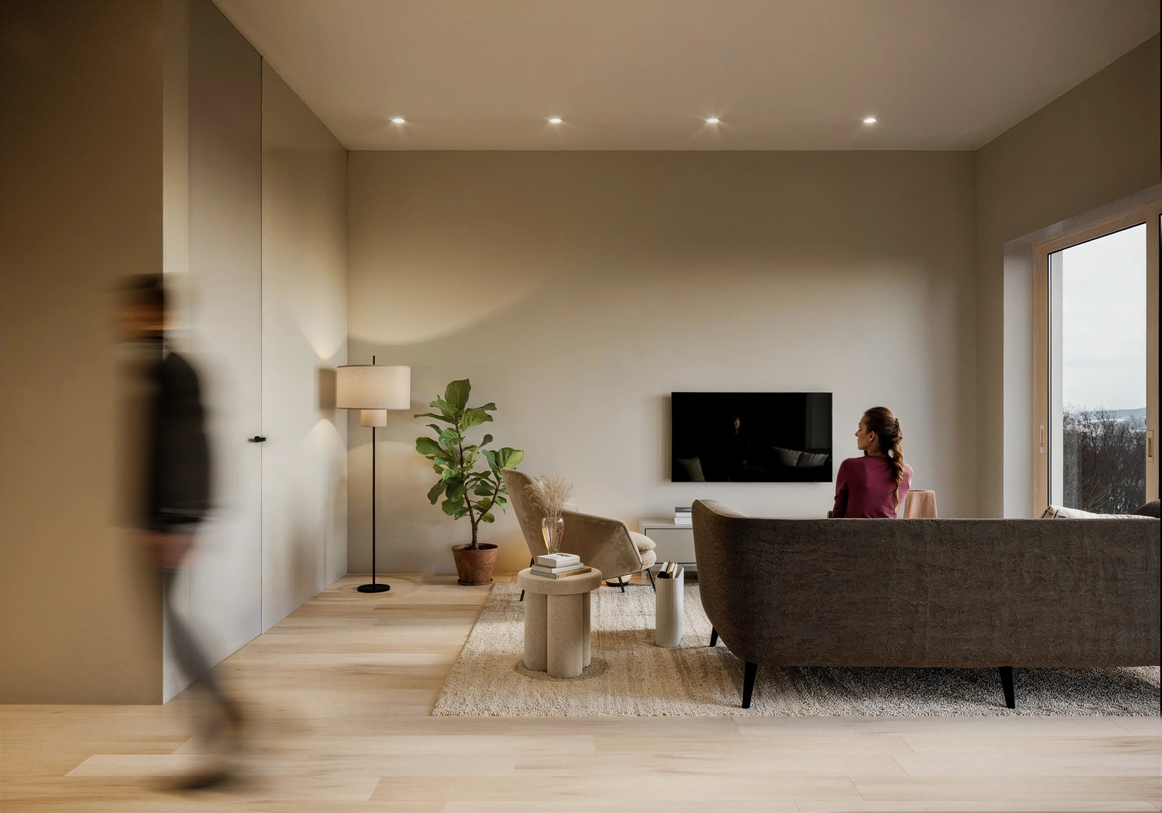 Open-plan living area with natural light, timber flooring and modern furnishings
